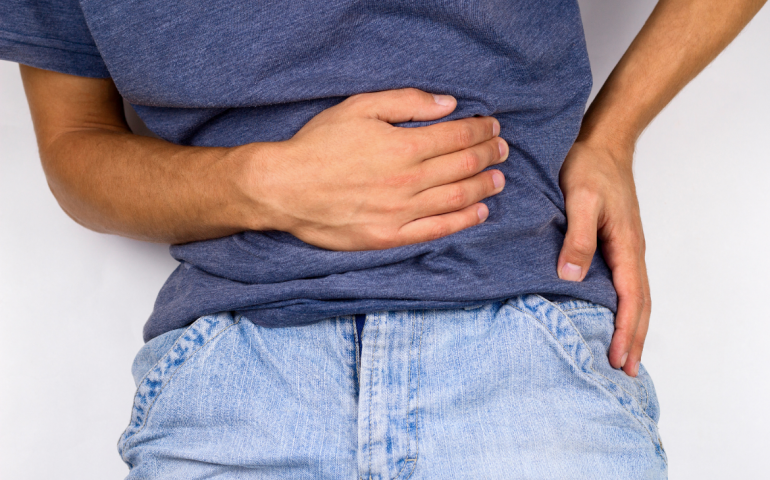 Man holding his stomach in pain