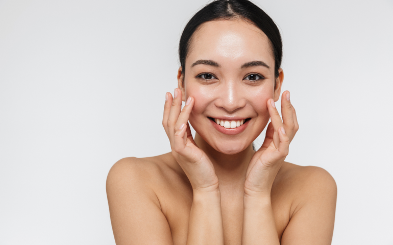 Woman touching her face after skin treatment