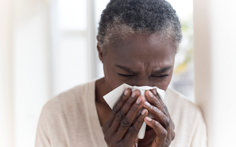 Woman blowing her nose