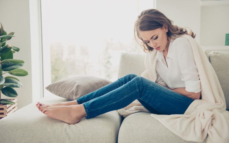 Woman holding her stomach in pain