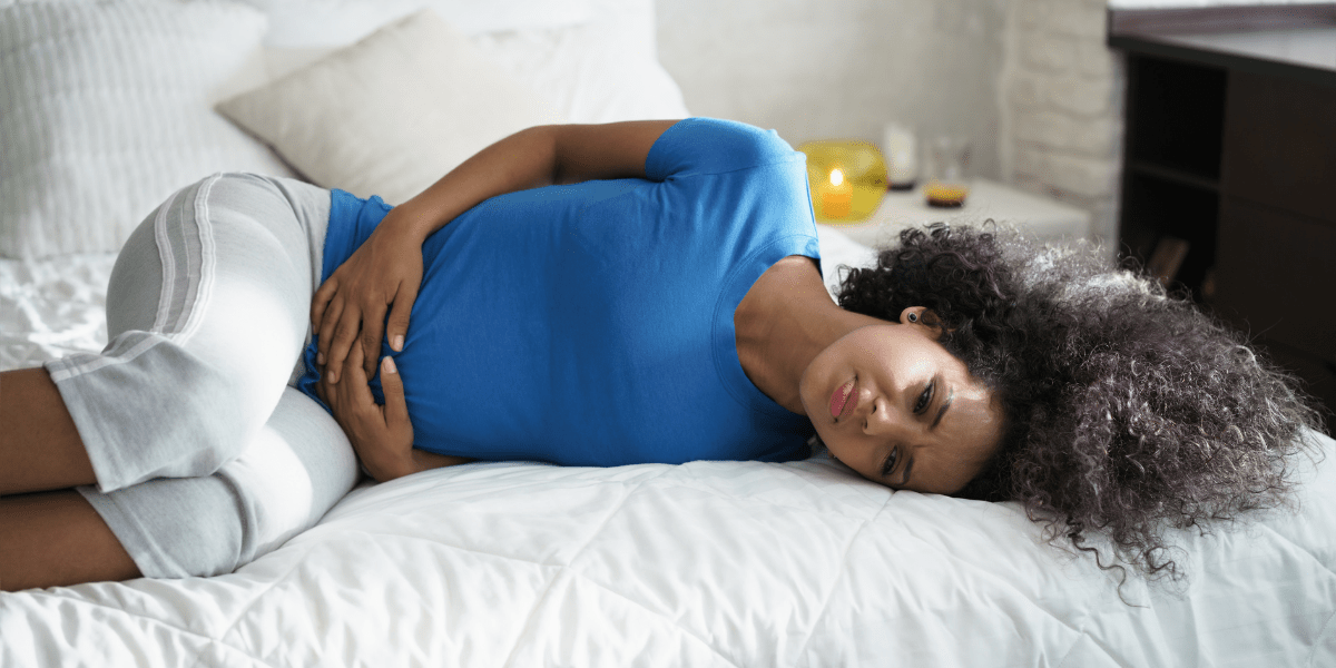 Woman holding her stomach in pain