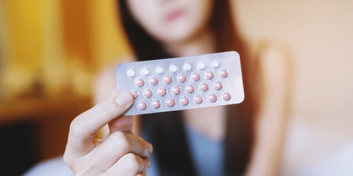 Woman holding a pack of contraceptive pills