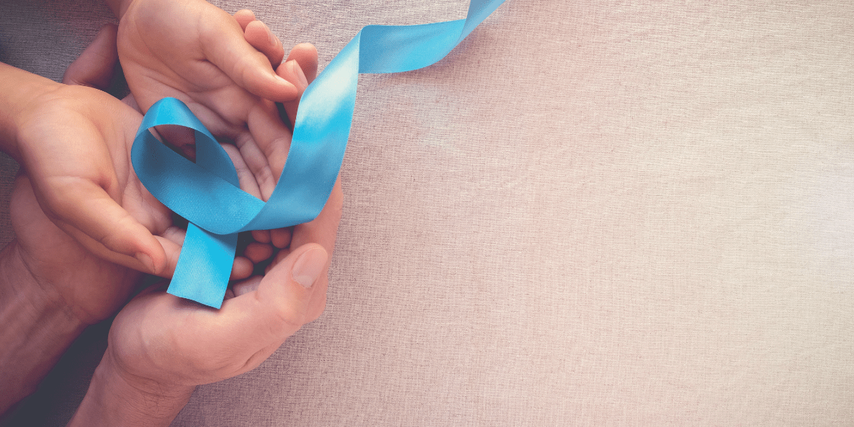 A child and an adult holding a blue ribbon